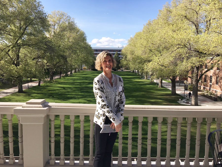 Amy Altick poses for a photo in front of the quad on the balcony of Morrill Hall.