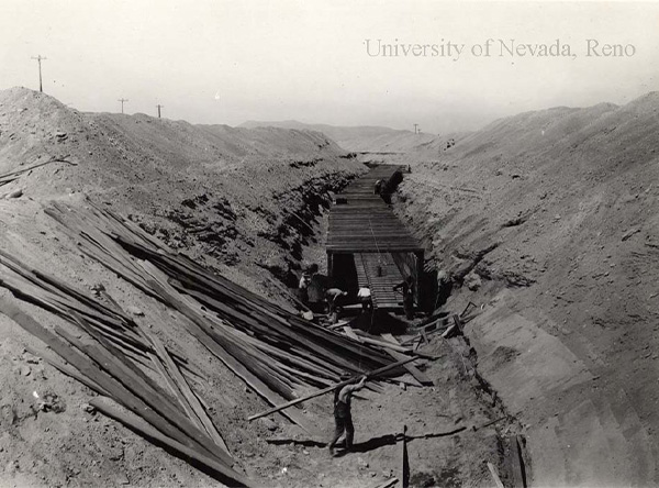 Scanned photograph of Bureau of Reclamation laborers working on constructing a ditch.