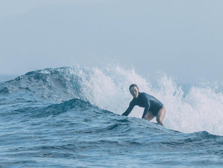 Heather Ernst surfing in the ocean.