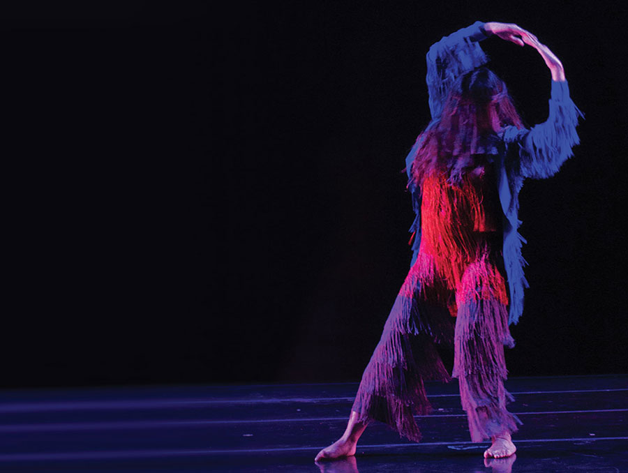 Dancer in fuzzy, hairy costume poses for dance performance