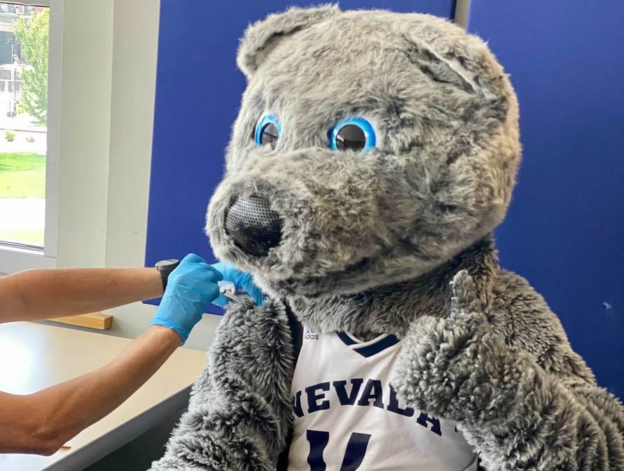 Alphie the mascot getting vaxxed