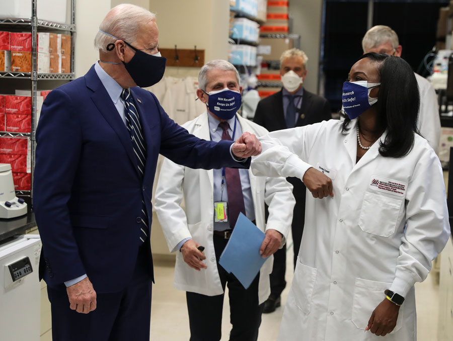 President Joe Biden greets Kizzmekia Corbett, an immunologist with the Vaccine Research Center at the National Institutes of Health during a visit at the Viral Pathogenesis Laboratory at the National Institutes of Health on Thursday, February 11, 2021 in Bethesda, Maryland.