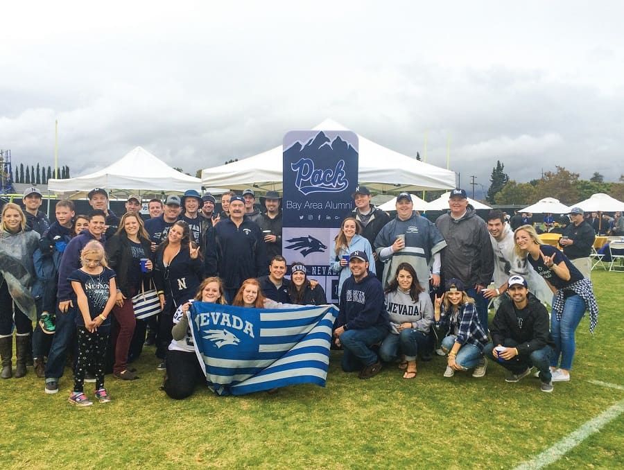 A group of people from the Bay Area Alumni Chapter wearing silver and blue Wolf Pack gear 