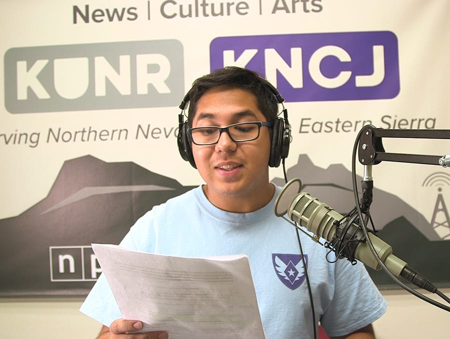 Andrew Mendez records voiceover in an audio studio at KUNR. 