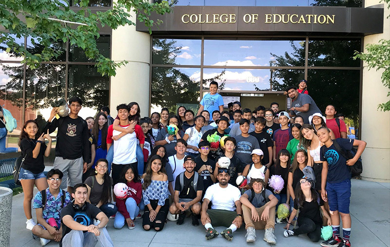 Manuel Ortiz with DFS students in front of the William Raggio Building