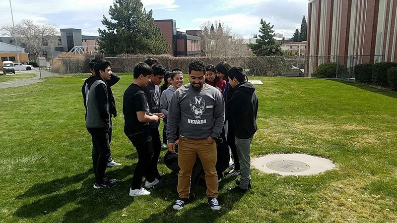 Manuel Ortiz with DFS students in a huddle