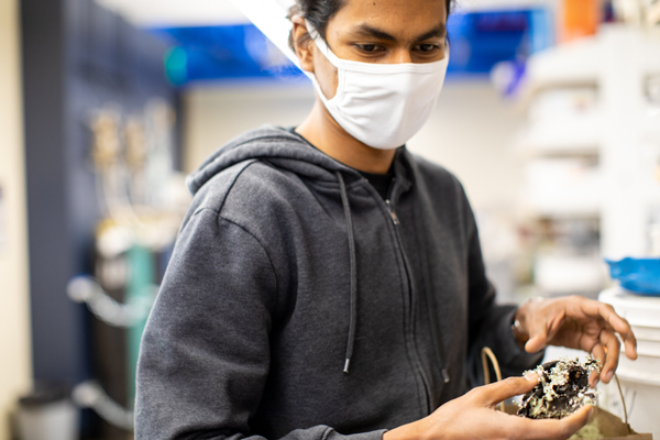 Tanzil Mahmud is a graduate student in Christopher Jeffrey’s lab. He is shown holding a lichen he collected for the lab on a hiking trip in Oregon.