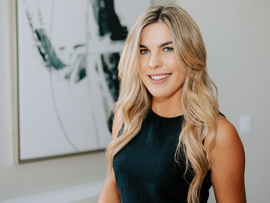 Liv Moore smiles to camera in front of a white background