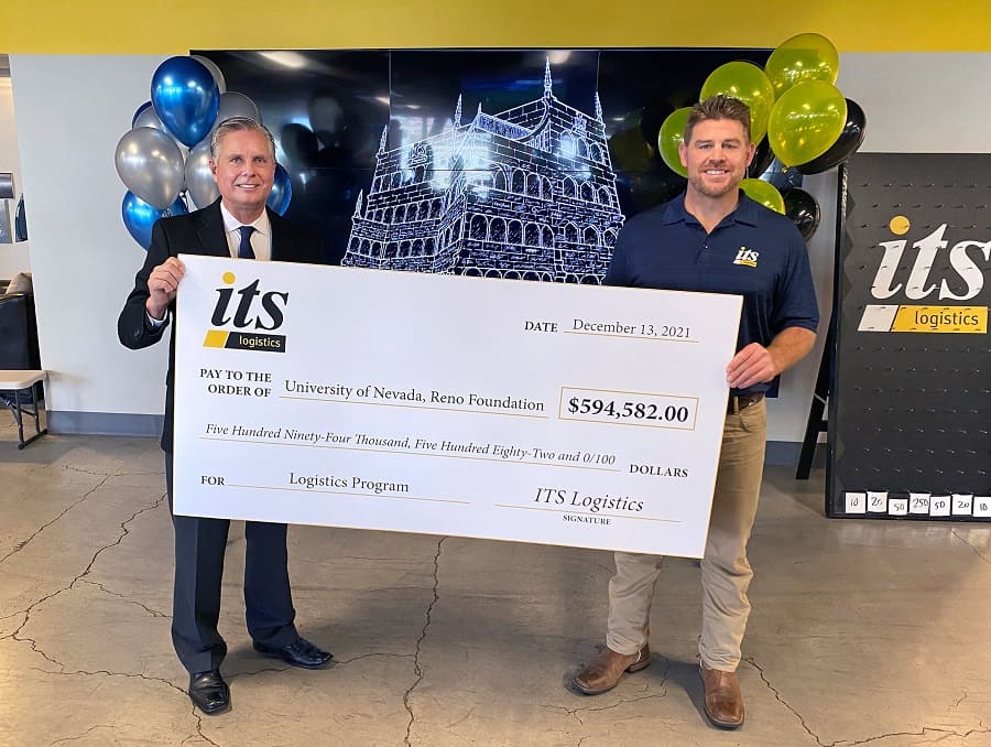 College of Business Dean Greg Mosier and ITS Logistics President Mike Crawford posing for a photo with a big check.