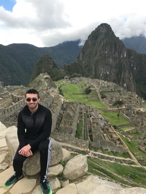 Shawn Thomas posing with a view of Machu Picchu