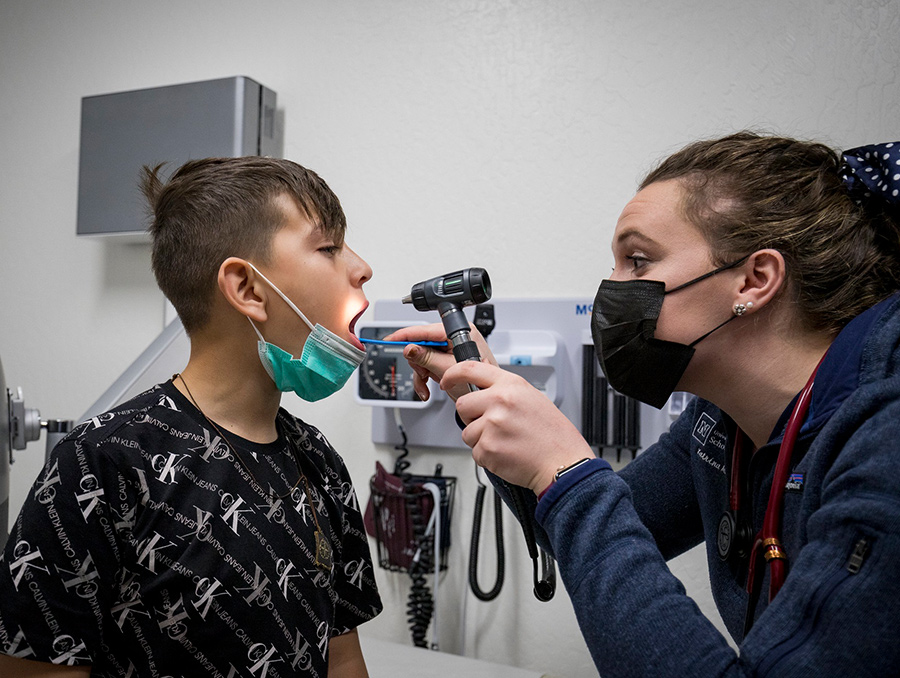 UNR Med fourth-year medical student, Katrina Marks, examines a young patient at a Student Outreach Clinic. Northern Nevadans who are uninsured
