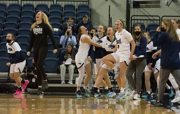 Nevada's bench celebrates Hamilton's three pointer before the half