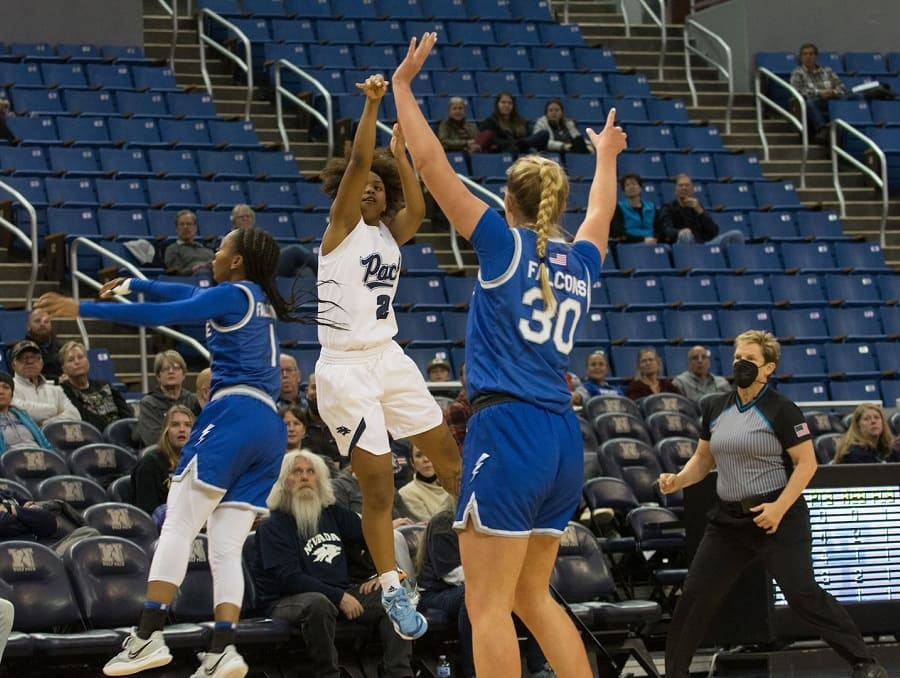 Da'Ja Hamilton makes a shot from behind two defenders while playing against the Air Force team