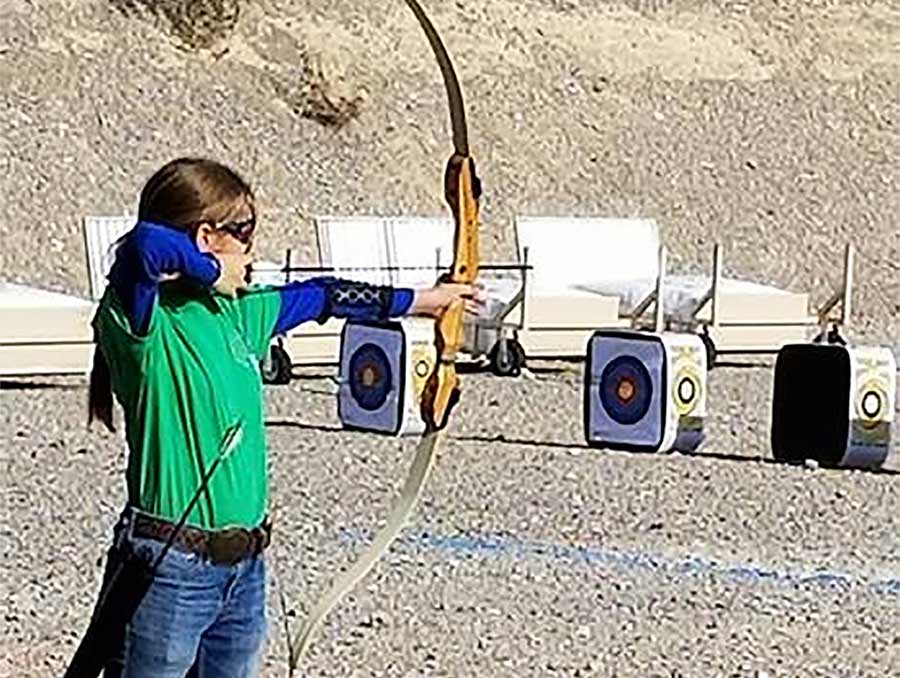 4-H youth shooting targets with a bow and arrow