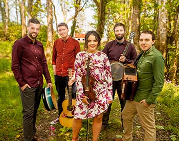 Irish quintet Goitse poses for a photo outside in a field