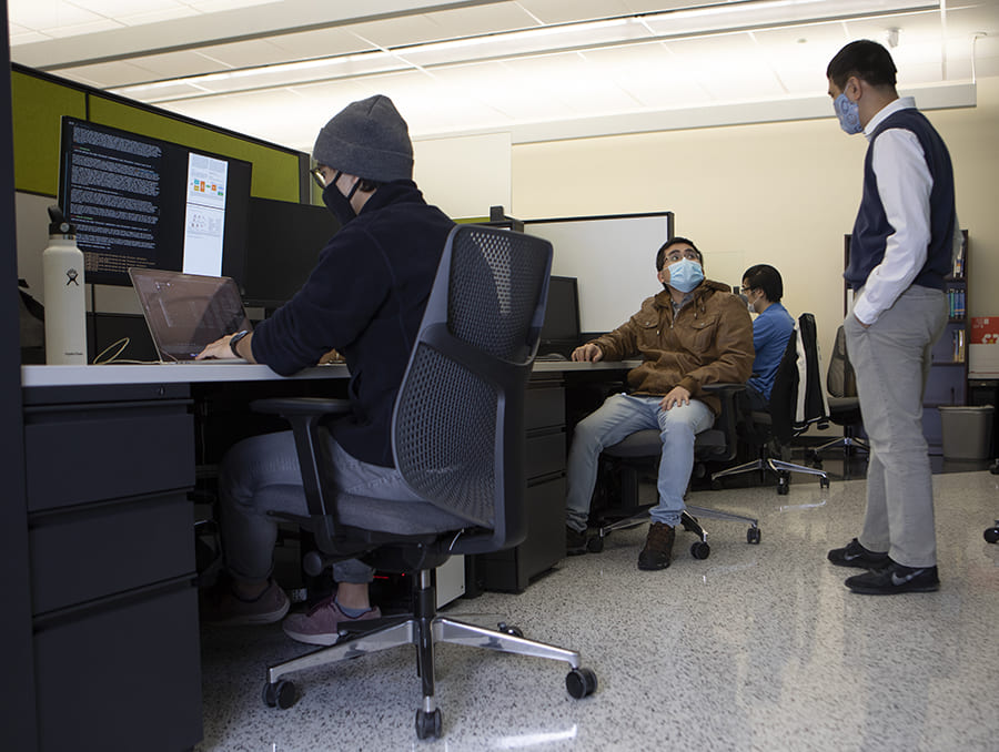 Four people in computer lab in William N. Pennington Engineering Building