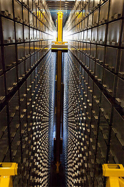 A library ARS robotic arm traversing an aisle 