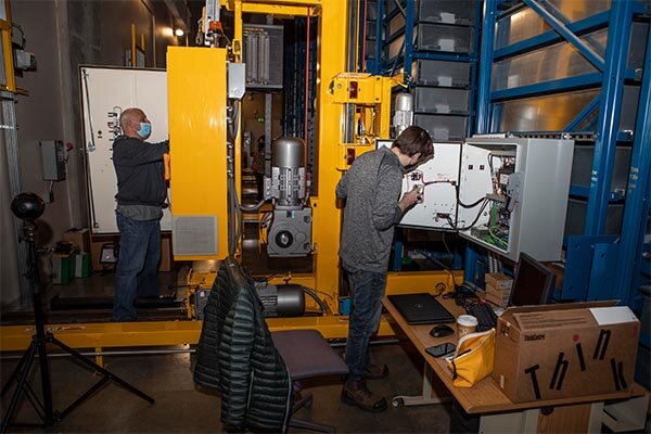 Two male technicians working on an ARS for maintenance