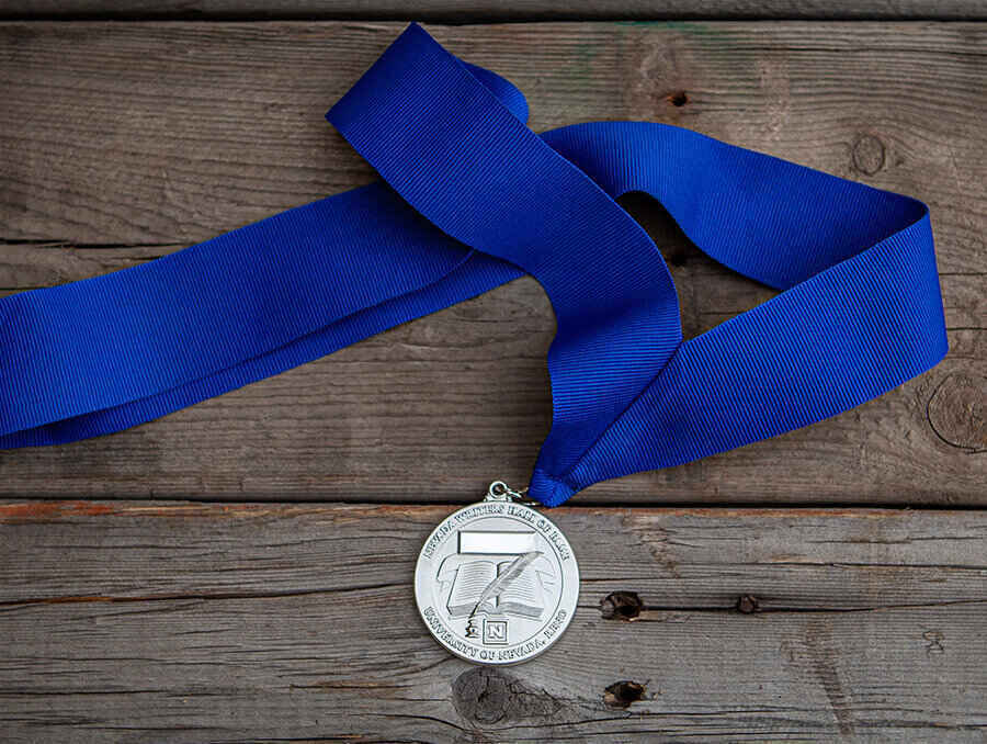 A silver medal with a blue ribbon