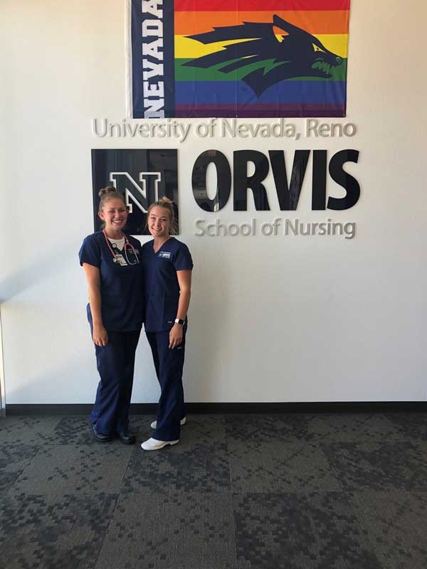 Haley Carroll and another nursing student at the entrance to the Orvis School of Nursing