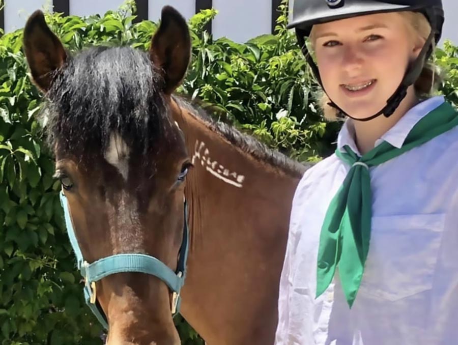 4-H youth Alexis with her horse Vinnie. 