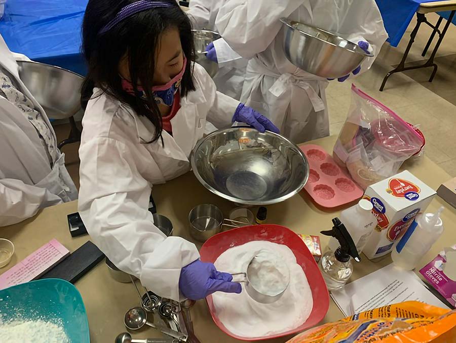 Young girl working on a science experiment. 