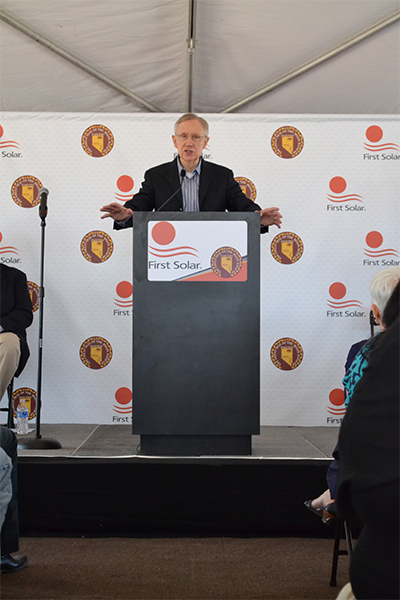 Senator Reid speaking being a podium at the ceremony of the Moapa Southern Paiute Solar Project