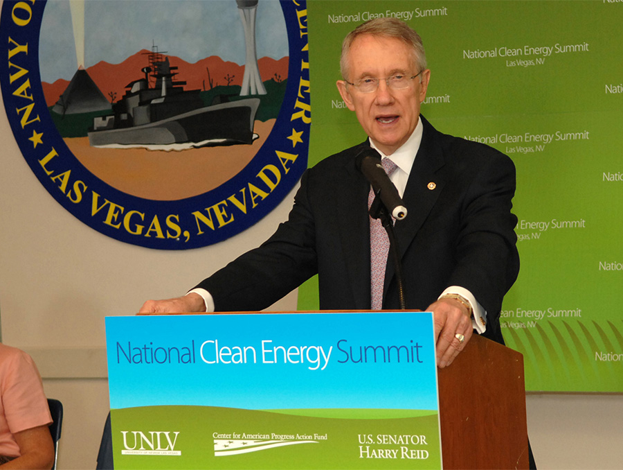 Photograph of Harry Reid present behind a podium at the National Clean Energy Summit