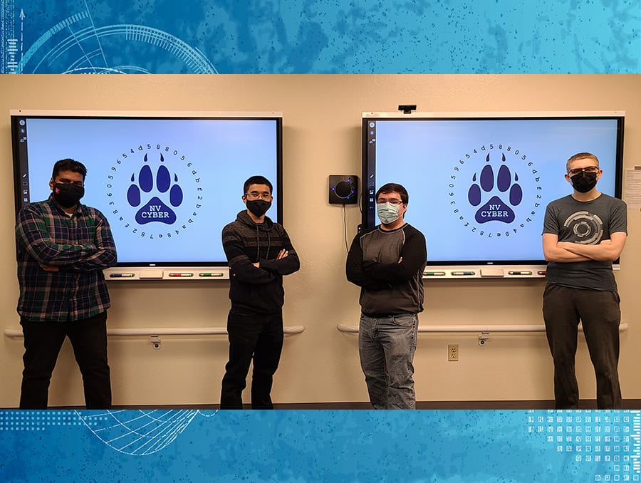 students wearing masks in front of television screens with Nevada Cyber Club logos