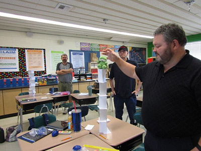 Teacher testing a mining lesson out in a classroom with spectators