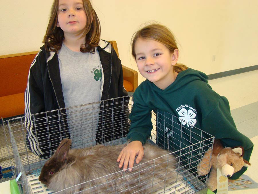 Two 4-H girls with their rabbit.