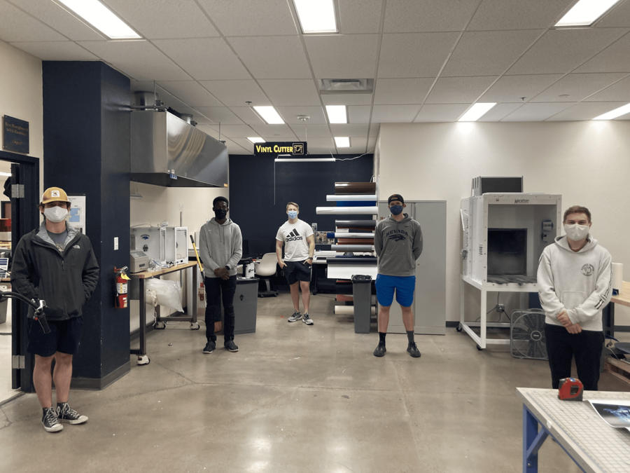 Five University students stand in the Makerspace. 