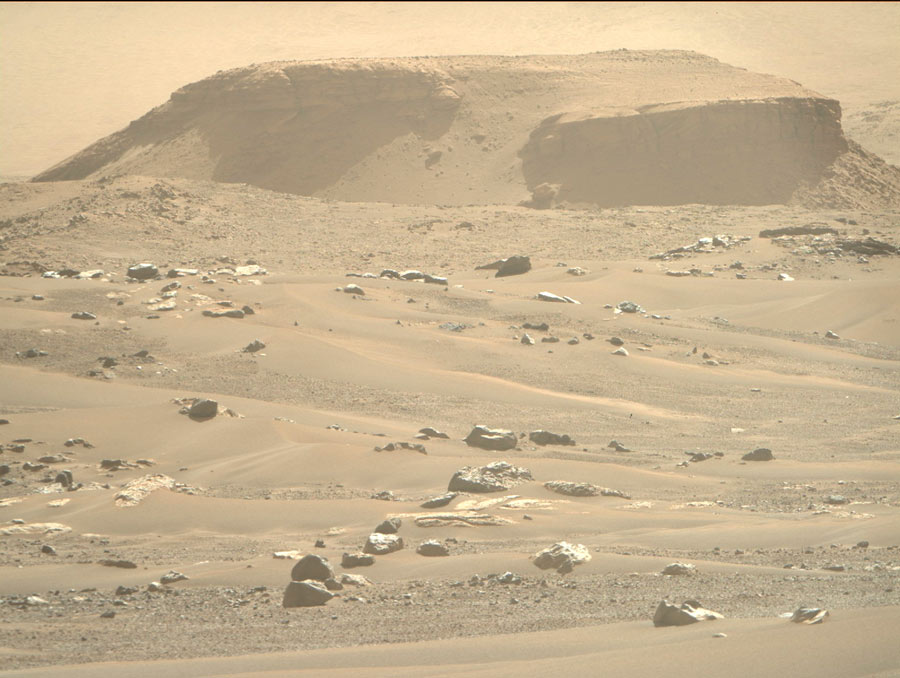 A sepia-toned photo shows the Mars landscape with a hill and rocky features.