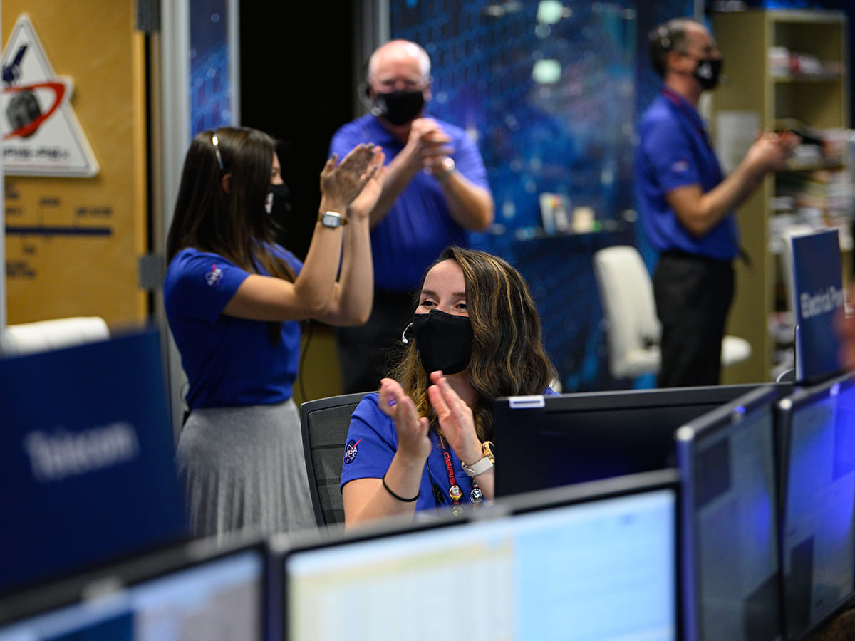 People celebrating in control room of Lockheed Martin