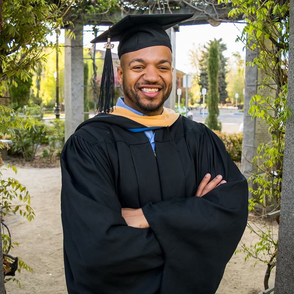 Steven Hammonds dressed in a graduation cap and gown