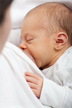 Mother breastfeeding an infant.