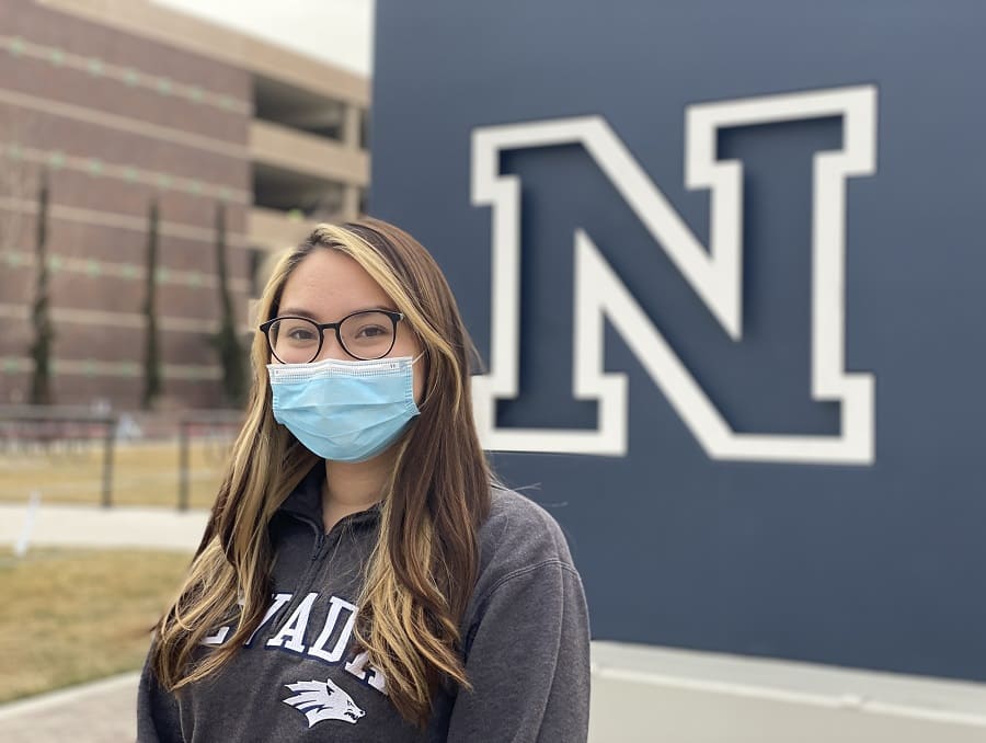 Mya Thomsen standing in front of the Nevada "N" on the University of Nevada, Reno campus.