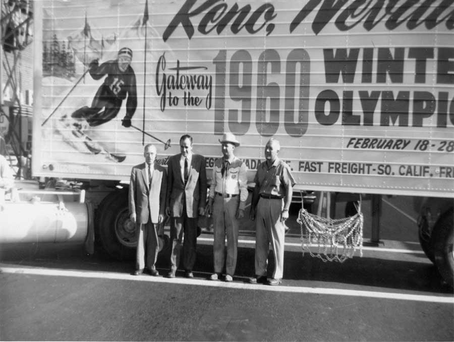 Four men standing in front of a bus at the Squaw Valley Olympics in 1960 