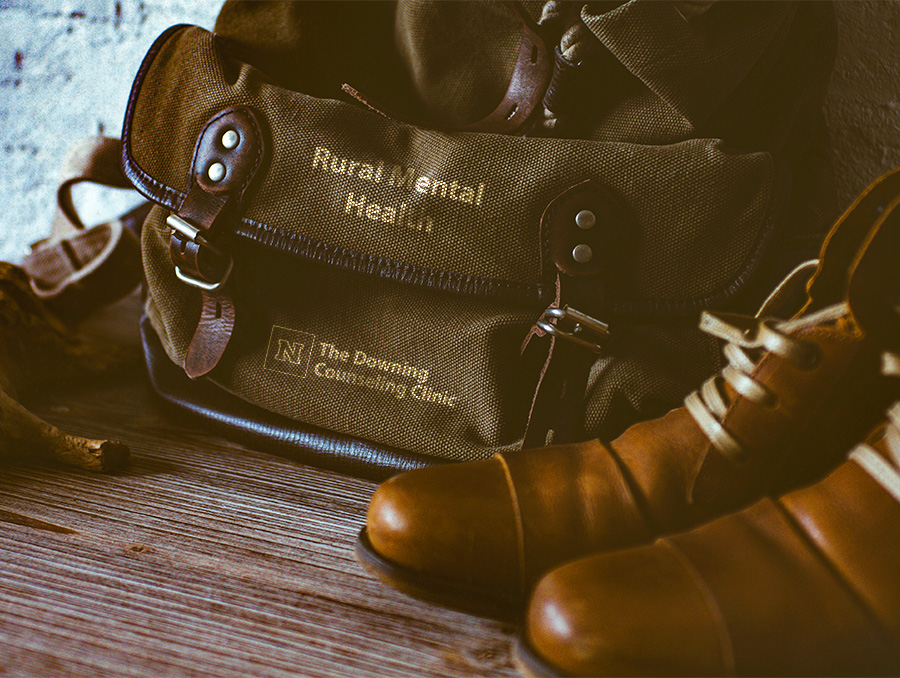 Photo of bag and shoes. The words "Rural Mental Health" are on the bag with the Downing Counseling Clinic logo