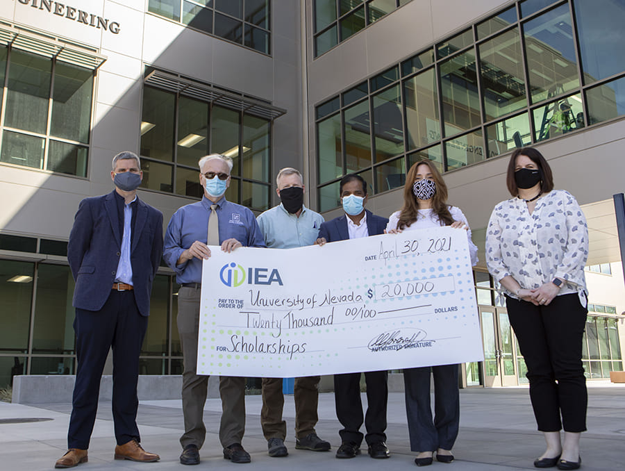 People standing in front of the William N. Pennington Engineering Building for a check presentation.