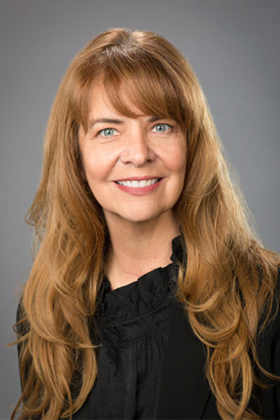 Photo of a woman with long hair wearing a black outfit