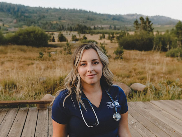 Zorha Benbrahim graduation photo in Orvis School of Nursing scrubs