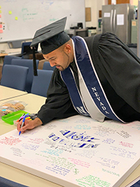 graduate signing scrapbook