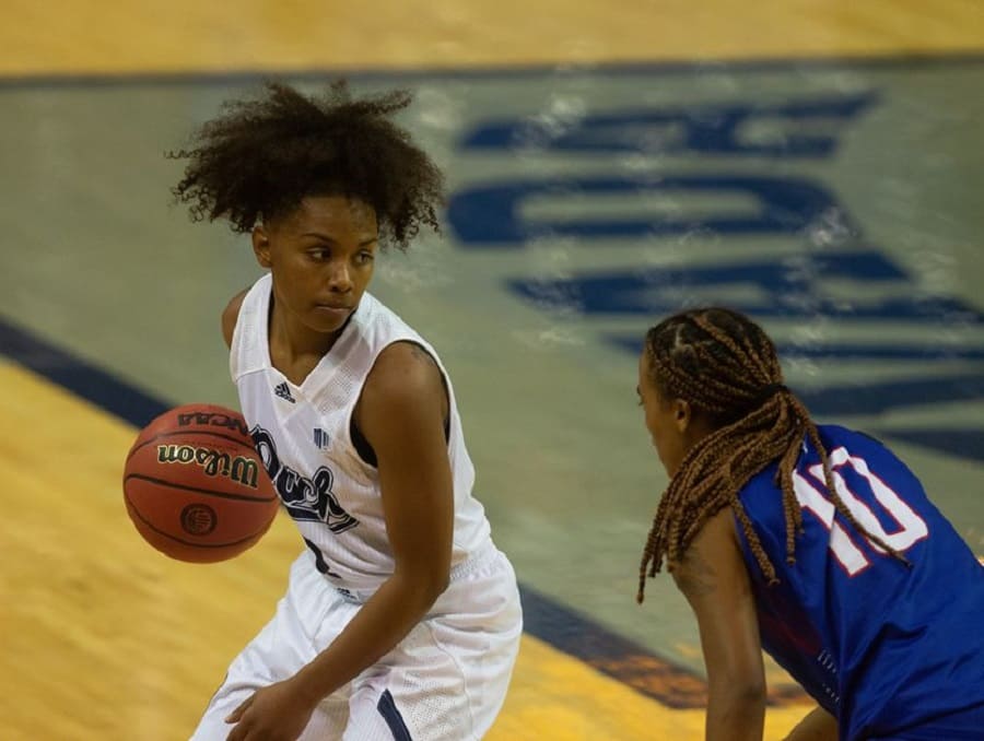 Wolf Pack Women's Basketball player Da'Ja Hamilton with the ball on the court during a game