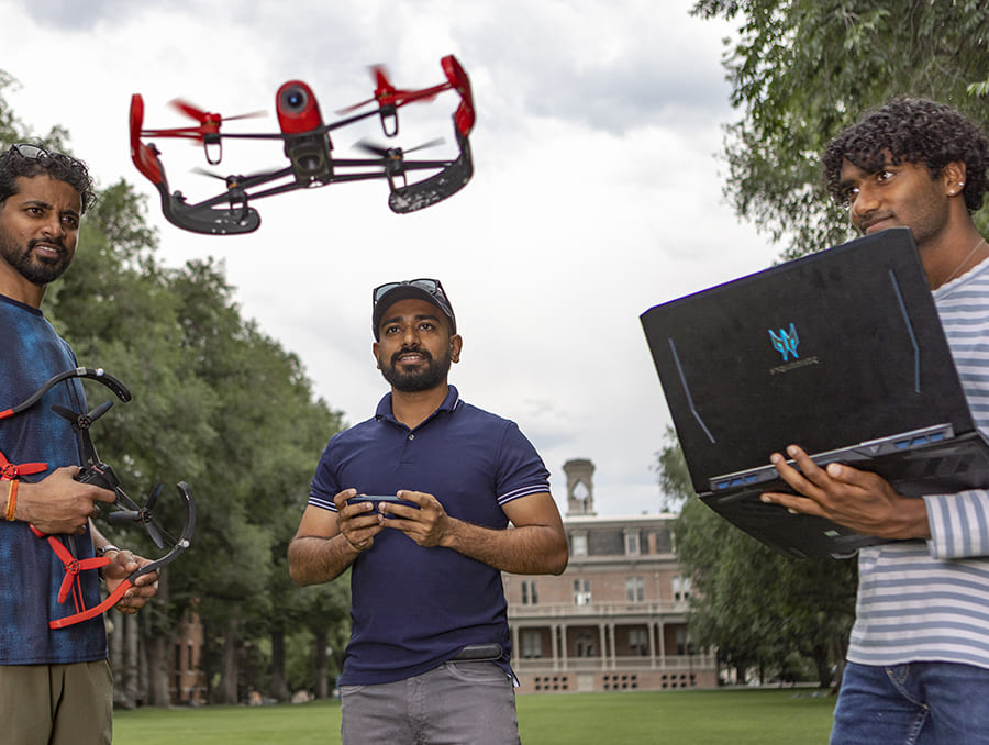 Students flying a drone on the Quad