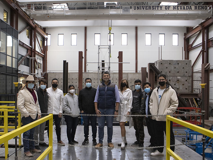 Researchers in the Earthquake Engineering Laboratory with a University of Nevada Reno banner.