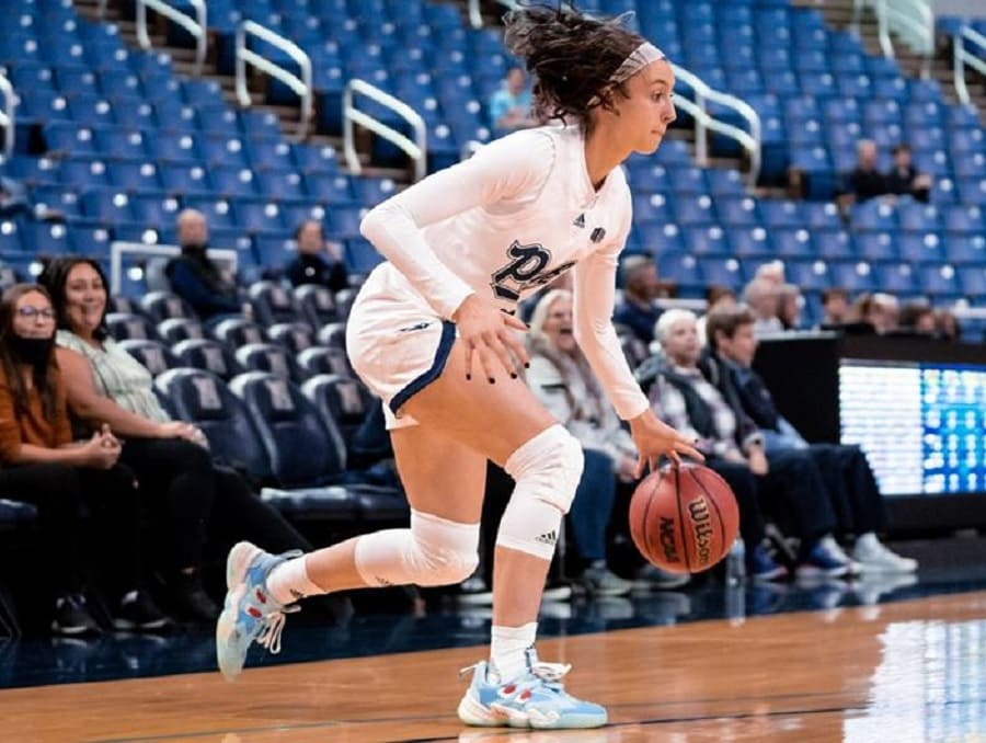 Audrey Roden on the court during a basketball game dribbling the ball