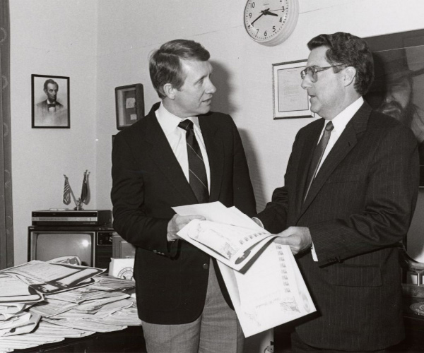 Harry Reid and John Herrington, Dept. of Energy Secretary hold papers while standing close to one another as they discuss Reid’s opposition to Yucca Mountain/Nuclear Waste Storage in Nevada.