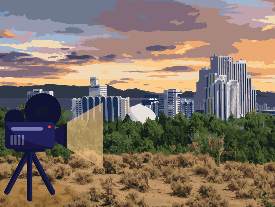 An illustration of the Reno skyline with a film camera projecting light on to it.