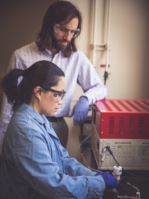 Christopher Barile and postdoctoral fellow Hanqing Pan conduct research in a lab.